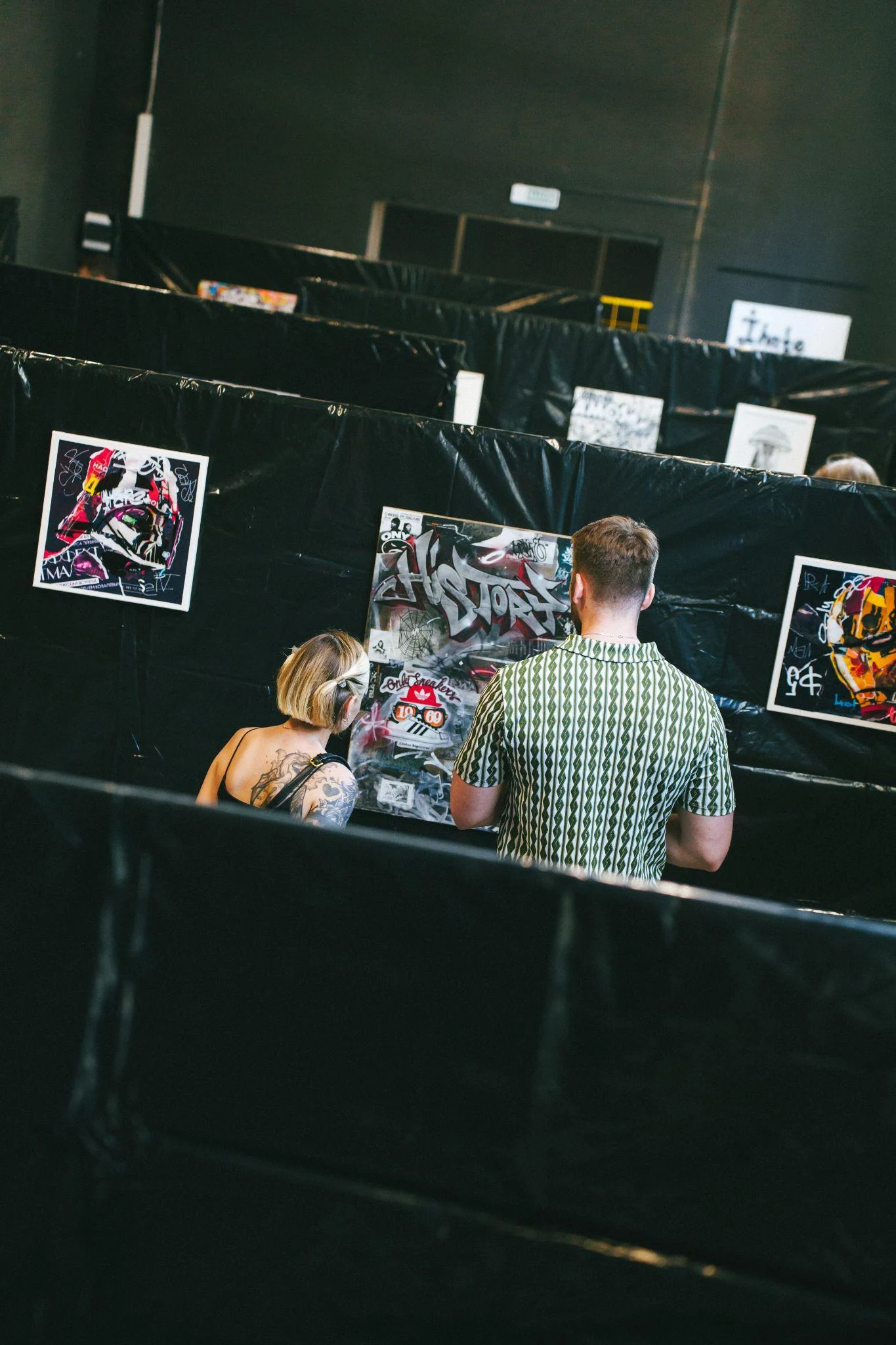 Visitors viewing works at B-Walls 2026