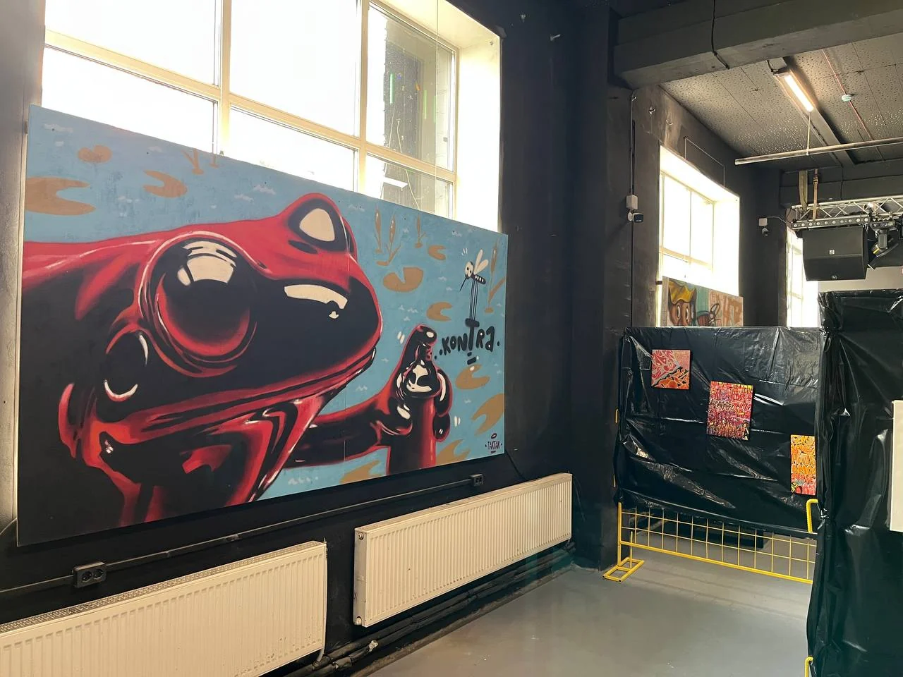 Artwork with a red character at B-Walls 2026