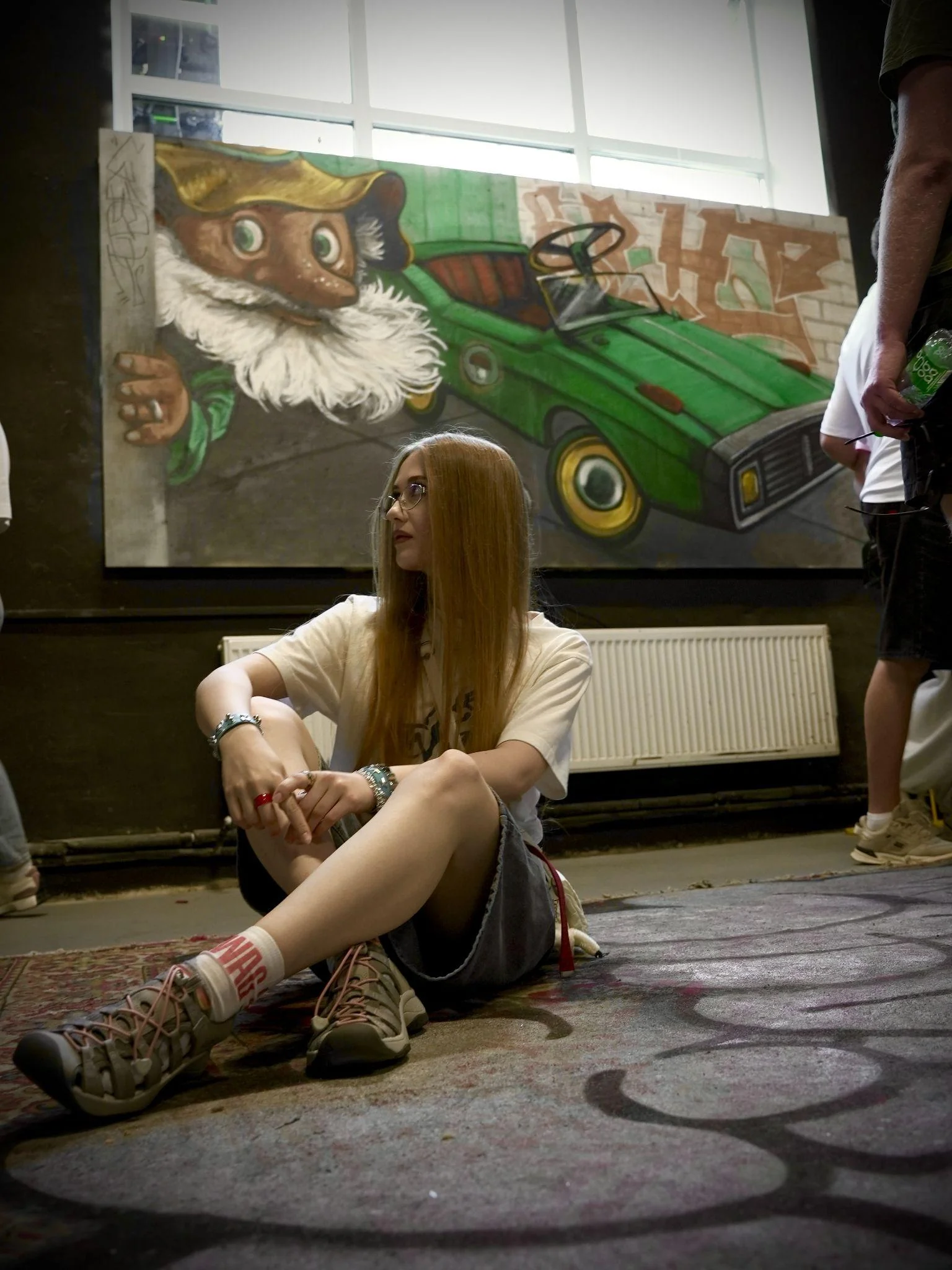 Visitor beside a canvas work