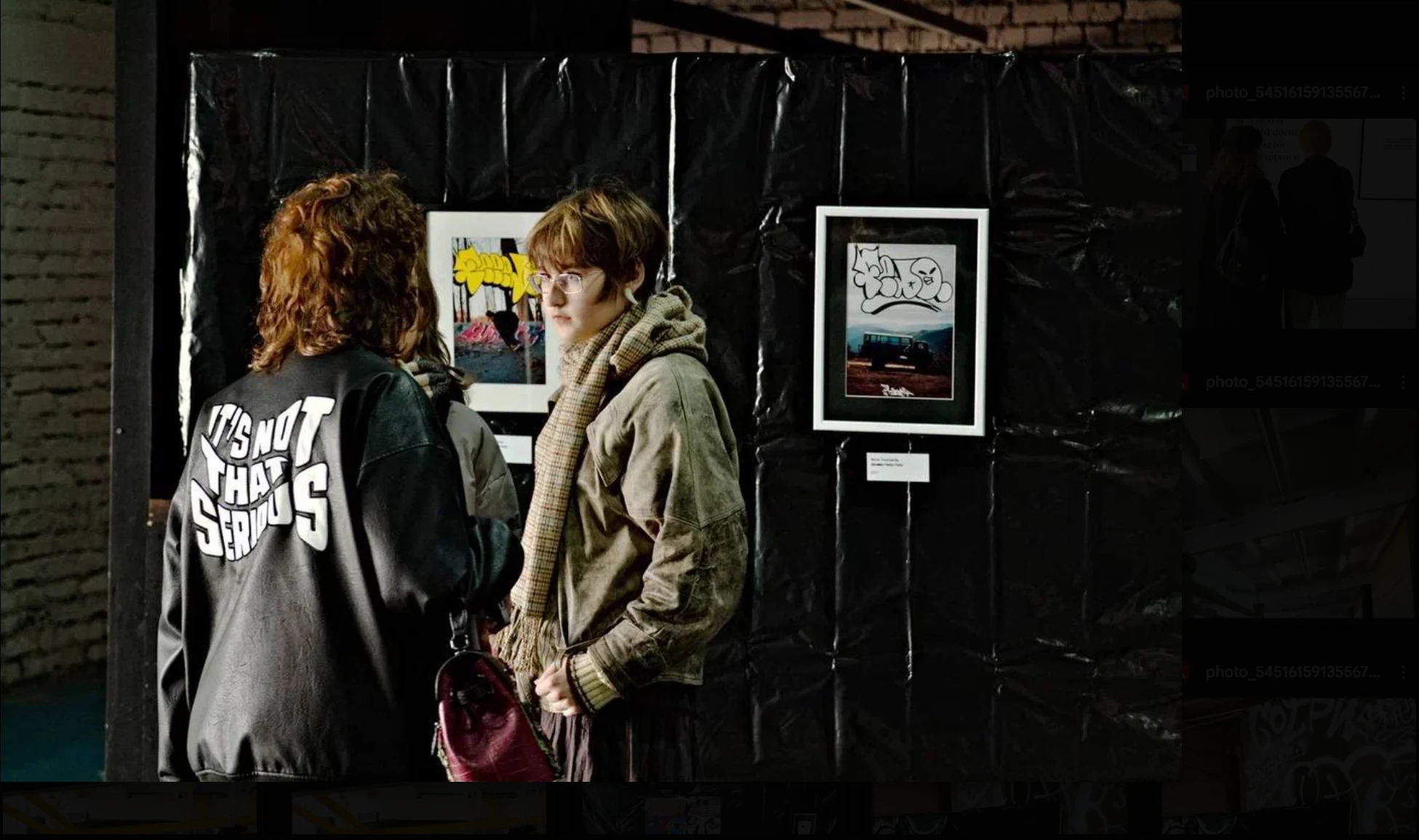 Visitors viewing artworks inside the B-Walls exhibition