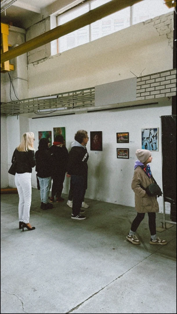 Visitors viewing artworks by the B-Walls artists