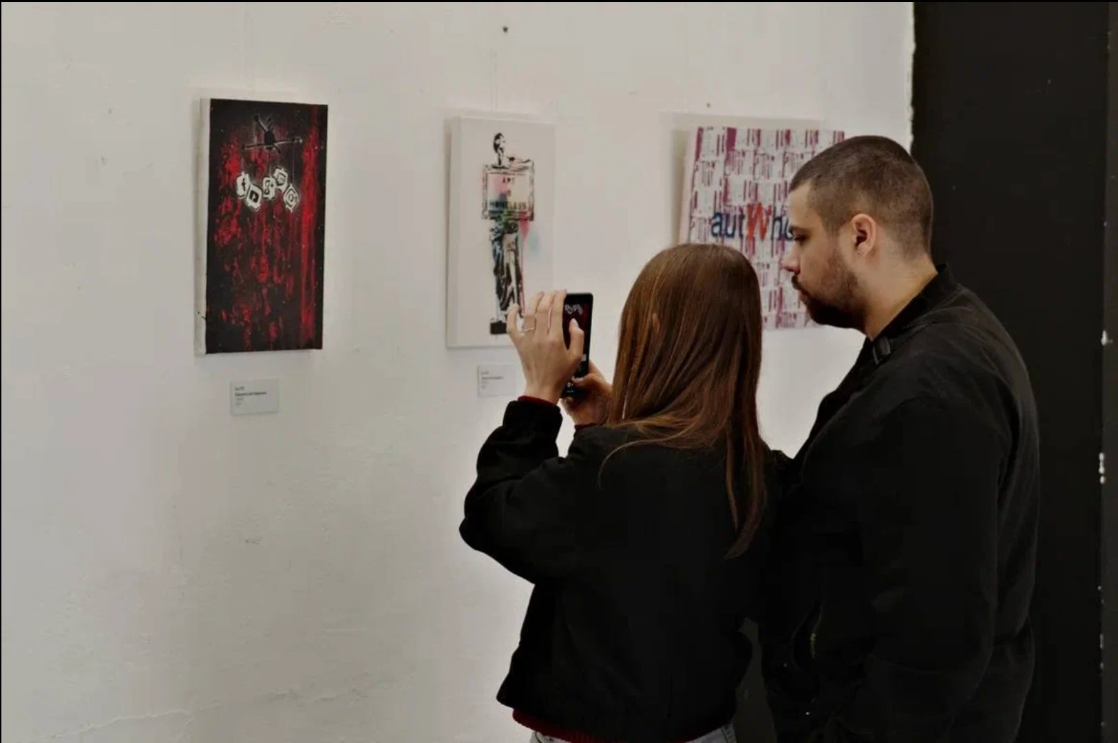 Visitors viewing artworks at the end of the B-Walls 2025 exhibition